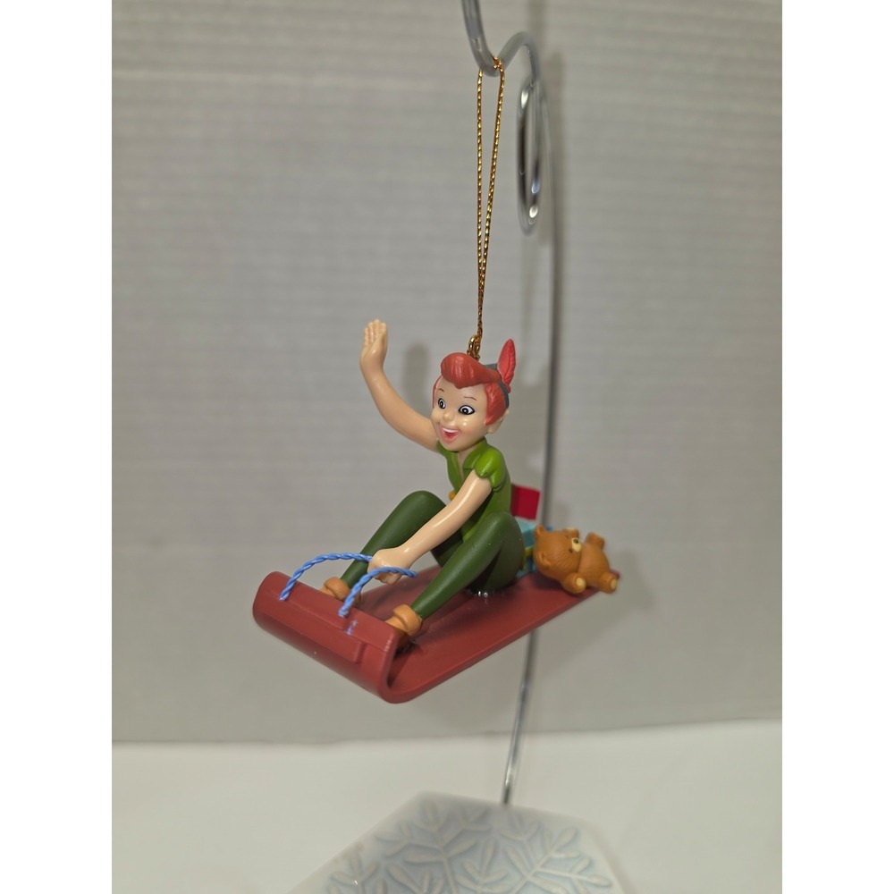 Vintage Disney Christmas ornament featuring Peter Pan riding a sled